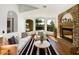 Bright living room featuring hardwood floors, a stone fireplace, and large windows with scenic views at 6255 S Opal Dr, Chandler, AZ 85249