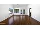 Bright living room with hardwood floors, view to backyard, and access to a bathroom at 6255 S Opal Dr, Chandler, AZ 85249