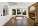 Bright living room featuring hardwood floors, a stone fireplace, and large windows with scenic views at 6255 S Opal Dr, Chandler, AZ 85249
