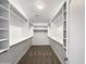 Spacious walk-in closet featuring built in shelves and clothing racks at 6255 S Opal Dr, Chandler, AZ 85249