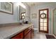 Bathroom featuring a wooden door with glass panels, granite countertops and tile floors at 6446 E Beverly Ln, Scottsdale, AZ 85254