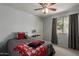 Bedroom with neutral walls, a ceiling fan, and a window with natural light at 6446 E Beverly Ln, Scottsdale, AZ 85254