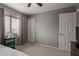 Cozy bedroom with neutral walls, a ceiling fan, and a window for natural light at 6446 E Beverly Ln, Scottsdale, AZ 85254