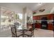 Breakfast nook showcases a glass table, backyard views, and stylish decor elements at 6446 E Beverly Ln, Scottsdale, AZ 85254