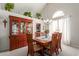 The dining room features a wood table, chairs, and a large china cabinet, complemented by an elegant chandelier at 6446 E Beverly Ln, Scottsdale, AZ 85254