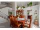 Dining room features a wooden table with six chairs, elegant chandelier, and built-in display cabinet at 6446 E Beverly Ln, Scottsdale, AZ 85254