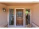 Close-up of an elegant front door with glass accents and sidelights for added natural light at 6446 E Beverly Ln, Scottsdale, AZ 85254