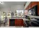 Kitchen view featuring stainless steel appliances, ample counter space, and backyard views at 6446 E Beverly Ln, Scottsdale, AZ 85254
