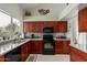 Well-lit kitchen featuring custom wood cabinets, modern appliances, and a stylish backsplash at 6446 E Beverly Ln, Scottsdale, AZ 85254
