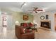 The living room showcases a cozy fireplace, ceiling fan, and comfortable leather seating at 6446 E Beverly Ln, Scottsdale, AZ 85254