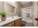 Bright bathroom with a tub and shower combination and warm-toned vanity with lots of counter space at 682 W Gum Tree Ave, Queen Creek, AZ 85140
