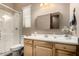 Bright bathroom features a walk-in shower, white countertops, and wood cabinets at 682 W Gum Tree Ave, Queen Creek, AZ 85140