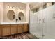Bright bathroom featuring double sinks, updated fixtures, and a spacious walk-in shower with glass enclosure at 682 W Gum Tree Ave, Queen Creek, AZ 85140