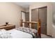 Simple bedroom featuring a skylight, wood trim, and sliding closet doors at 682 W Gum Tree Ave, Queen Creek, AZ 85140