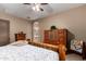 Inviting bedroom featuring an attached bathroom, ceiling fan, and log-frame furniture at 682 W Gum Tree Ave, Queen Creek, AZ 85140