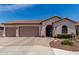 Charming single-story home with a tile roof, three-car garage, arched entry, and landscaped front yard at 682 W Gum Tree Ave, Queen Creek, AZ 85140