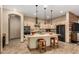 Open kitchen with granite countertops, pendant lighting, stainless steel appliances, and a large island at 682 W Gum Tree Ave, Queen Creek, AZ 85140