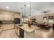 Well-designed kitchen featuring a central island, modern appliances, and seamless flow to the dining and living areas at 682 W Gum Tree Ave, Queen Creek, AZ 85140