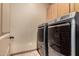 Convenient laundry room with a washer and dryer, and ample cabinet space at 682 W Gum Tree Ave, Queen Creek, AZ 85140