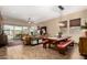 Open-concept living area with wood-look tile flooring, a dining table, and sliding glass doors to the backyard patio at 682 W Gum Tree Ave, Queen Creek, AZ 85140