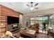 Comfortable living room with wood accent wall, large sliding glass doors to backyard, and stylish furnishings at 682 W Gum Tree Ave, Queen Creek, AZ 85140