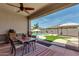 Covered patio with outdoor dining area, view of the swimming pool, and a well-maintained backyard space at 682 W Gum Tree Ave, Queen Creek, AZ 85140
