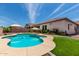 Beautiful backyard with a pool, green grass, plants and patio areas at 682 W Gum Tree Ave, Queen Creek, AZ 85140