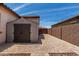 Durable storage shed sitting adjacent to a house and brick perimeter wall, on a paved driveway at 682 W Gum Tree Ave, Queen Creek, AZ 85140