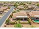 Aerial view of the property with an extended covered patio, landscaped backyard, and refreshing swimming pool at 6931 S Four Peaks Way, Chandler, AZ 85249