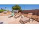 Relaxing backyard patio featuring a grill and multiple lounge chairs for entertainment at 6931 S Four Peaks Way, Chandler, AZ 85249