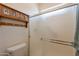 Bright bathroom featuring a shower with sliding doors and decorative shelf with coat hooks at 6931 S Four Peaks Way, Chandler, AZ 85249