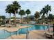 Stunning community pool surrounded by mature palm trees and shaded seating areas at 6931 S Four Peaks Way, Chandler, AZ 85249