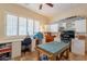 Craft room featuring tiled floors, work stations, and a large window with shutters at 6931 S Four Peaks Way, Chandler, AZ 85249