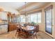 Bright dining room area with table and chairs, large windows and natural light at 6931 S Four Peaks Way, Chandler, AZ 85249