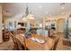 Open dining area with wooden table and chairs connected to kitchen at 6931 S Four Peaks Way, Chandler, AZ 85249