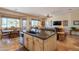 Open kitchen with granite island and sink, adjoined to dining and living area at 6931 S Four Peaks Way, Chandler, AZ 85249