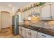 Kitchen features granite countertops, stainless steel appliances, and stone backsplash at 6931 S Four Peaks Way, Chandler, AZ 85249