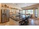 Spacious kitchen with a granite island, stainless steel appliances, and open dining area at 6931 S Four Peaks Way, Chandler, AZ 85249