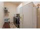 Practical laundry room with appliances and white cabinets for organized storage at 6931 S Four Peaks Way, Chandler, AZ 85249