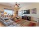 Cozy living room with a large window, comfortable seating, and a stylish entertainment center at 6931 S Four Peaks Way, Chandler, AZ 85249