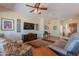 Bright living room with an entertainment center, comfortable seating, and open access to the foyer at 6931 S Four Peaks Way, Chandler, AZ 85249