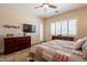This main bedroom features ceiling fan, TV, and lots of natural light at 6931 S Four Peaks Way, Chandler, AZ 85249