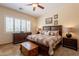 Comfortable main bedroom features ceiling fan, a sitting area, and plenty of natural light at 6931 S Four Peaks Way, Chandler, AZ 85249
