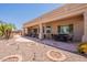 Extended covered patio area with lush landscaping and outdoor living spaces at 6931 S Four Peaks Way, Chandler, AZ 85249