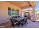 Covered patio with dining table and chairs, ideal for alfresco meals at 6931 S Four Peaks Way, Chandler, AZ 85249