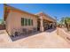 Covered patio with seating overlooking well-manicured landscaping at 6931 S Four Peaks Way, Chandler, AZ 85249
