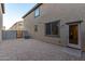 Exterior backyard featuring a door entrance, windows, and a pebbled ground at 822 E Agua Fria Ln, Avondale, AZ 85323