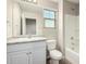 Bathroom with white vanity, granite countertop, and a tub/shower combo at 822 E Agua Fria Ln, Avondale, AZ 85323