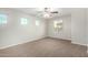 Bright bedroom with three windows, neutral walls, carpet, and a ceiling fan for added comfort at 822 E Agua Fria Ln, Avondale, AZ 85323