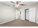 Bedroom features carpeted floors, a closet, a ceiling fan, and neutral walls at 822 E Agua Fria Ln, Avondale, AZ 85323